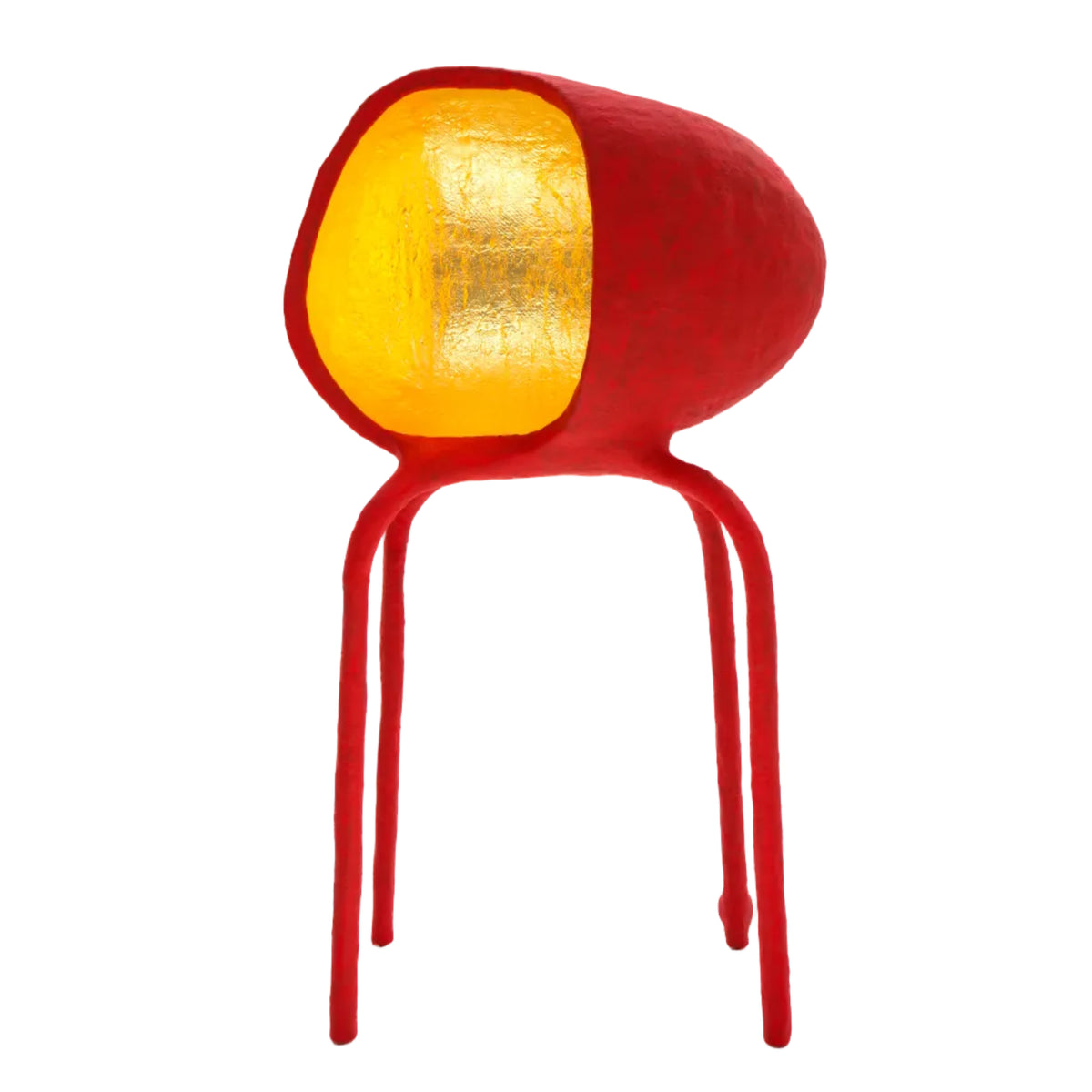 A sculptural table lamp shaped like a stylized red chair with a textured, organic red body, three thin legs, and a large oval yellow glass shade on a white background.