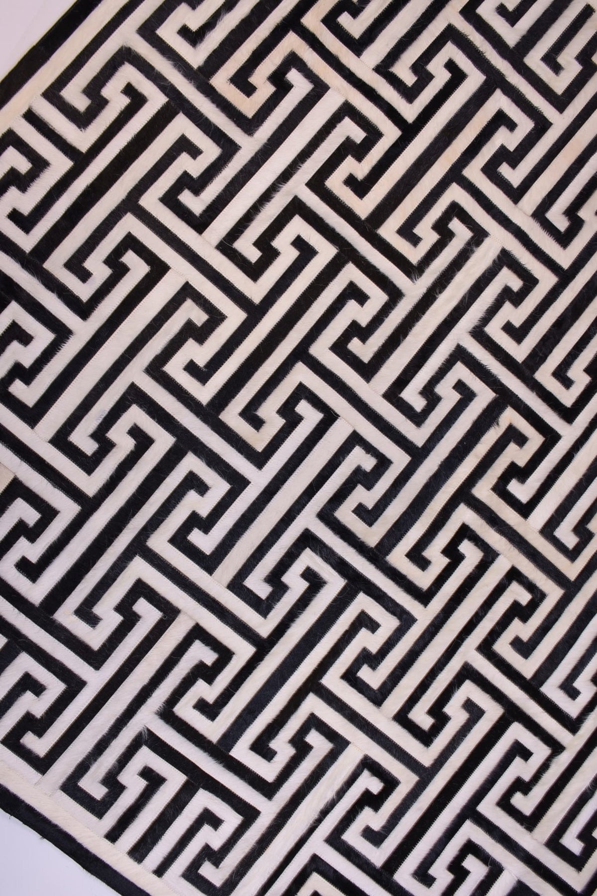 T MODEL – Maze-Inspired Cowhide Patch Rug - Homelosophy