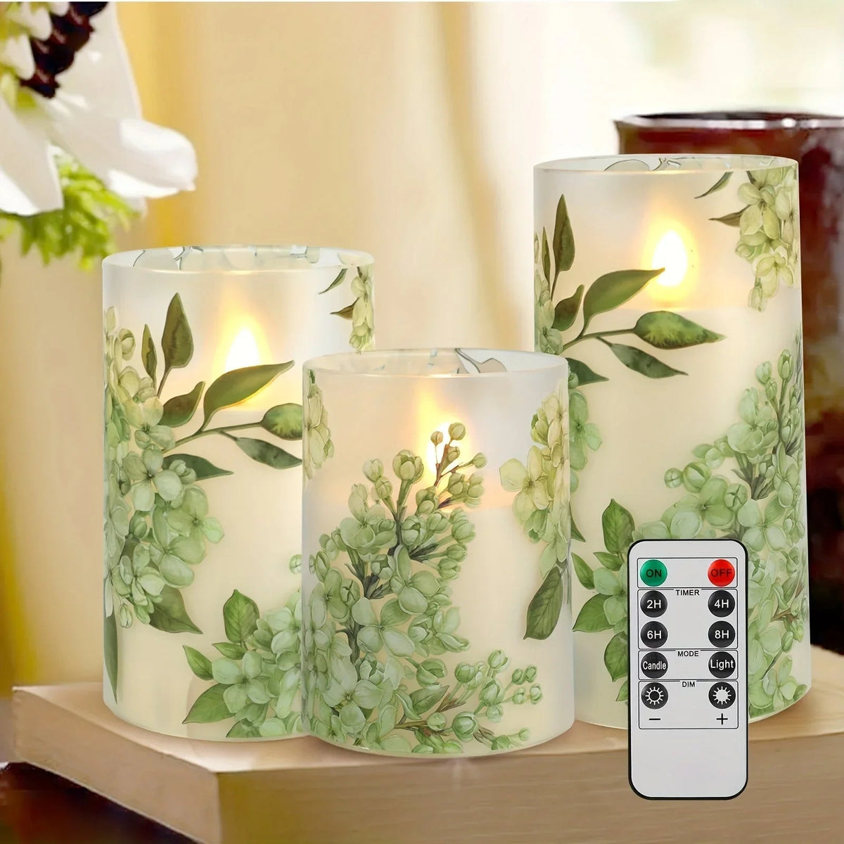 A set of 3 flameless candles, flickering LED pillar candles, with a 10-button remote control. They feature a g — House of Avana, view 1 of 14